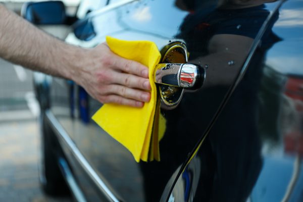 A man rubs a car. Car wash. Clear car concept